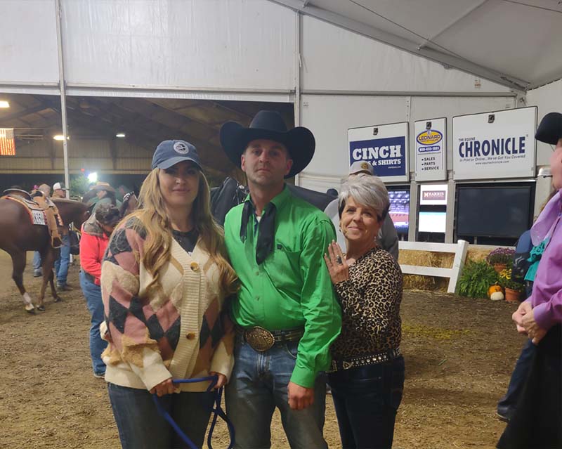 Andie - Andie Smiling and Standing Next to a Man and Woman at a Horse Show
