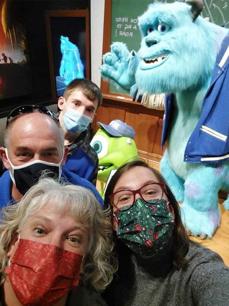 Susan - With a Mask on Smiling with Family at Monsters Inc.